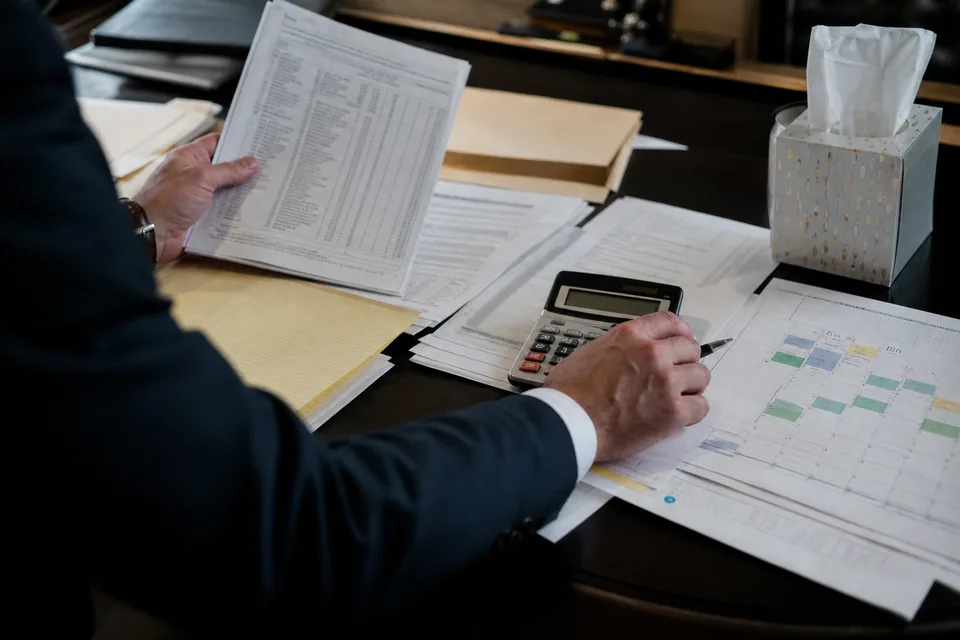Family law attorney's desk with financial statements and a parenting schedule
