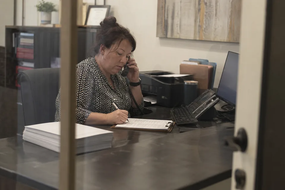 Intake coordinator on a phone call filling in a client intake form